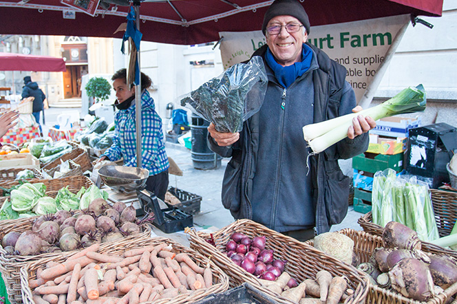 St Nics Market Farmer holding up fresh produce