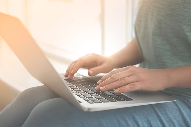 Laptop on lap with someone typing