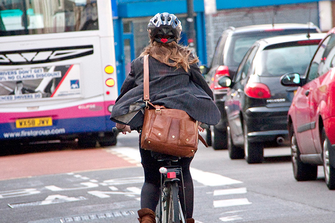 Cyclist commuting through traffic
