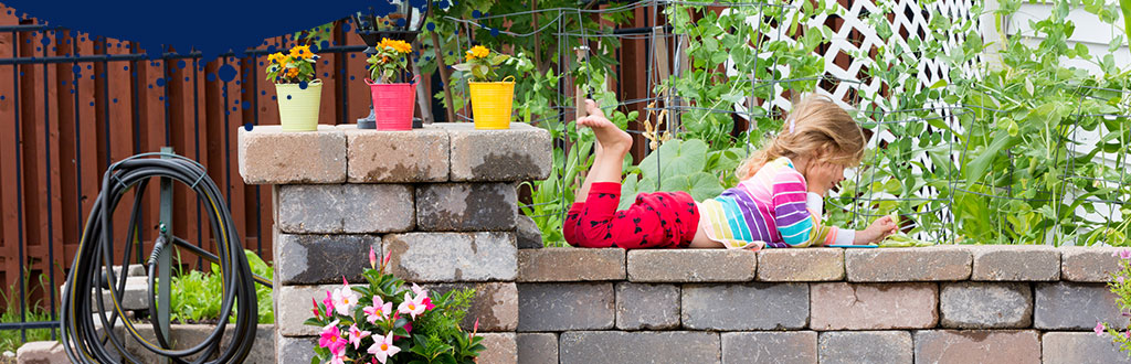 Girl on wall Young girl lying down on garden wall thinking