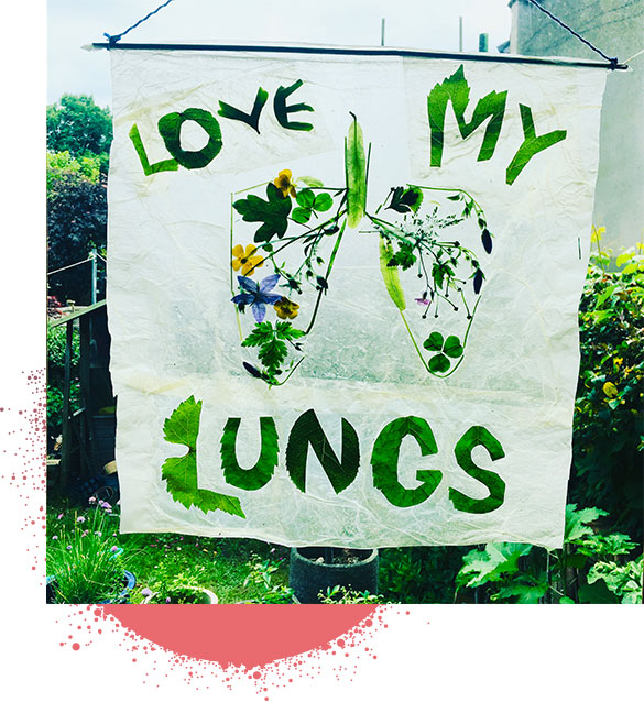 Hand crafted banner with illustration of lungs and the message "Love My Lungs" made from green leaves.