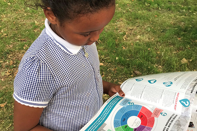 Young girl looking are carbon footprint report.