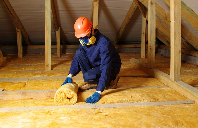 Man installing loft insulation